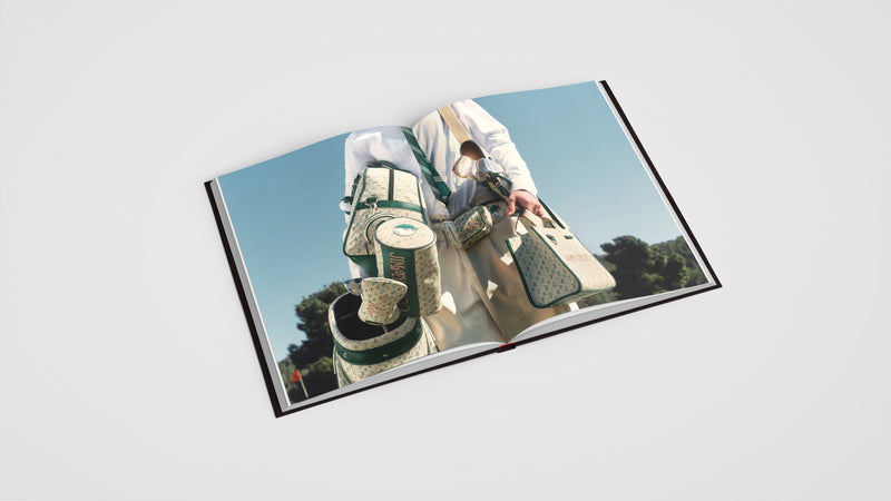 double page book spread with man h oling luxurious luggage and bags