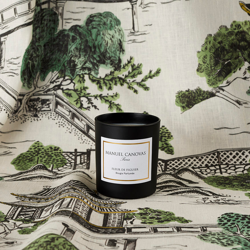 Manuel Canovas candle on a decorative fabric background