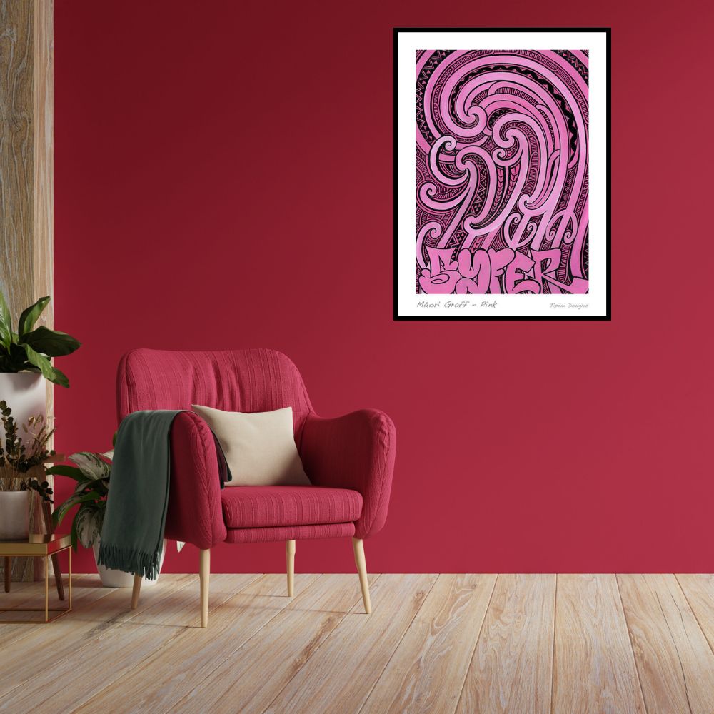Living room with a red armchair, pink wall, and framed artwork.