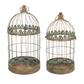 Two decorative bird cages with intricate designs on a white background