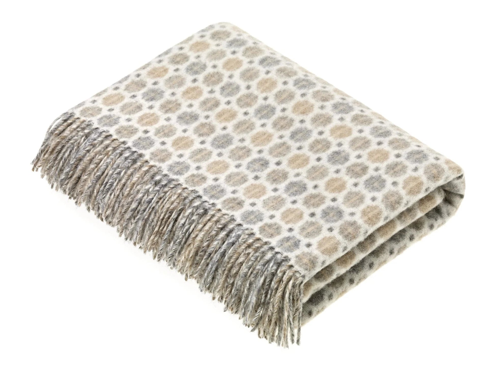 Folded Milan merino throw with a pattern and fringes on a white background