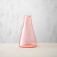 Hand blown glass carafe without a handle in apricot colour