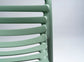 Green slatted chair against a light gray background