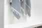 Striped towel with frayed edges on a white surface