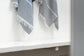 Striped towel hanging on a white shelf