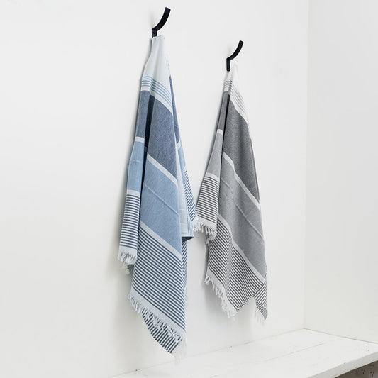 Two striped towels hanging on hooks against a white wall.