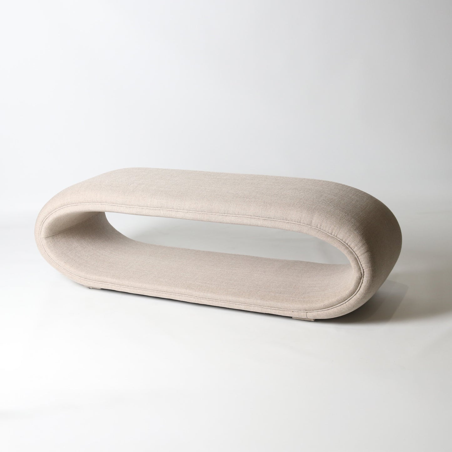 open oval upholstered bench in cream
