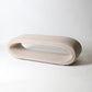 open oval upholstered bench in cream
