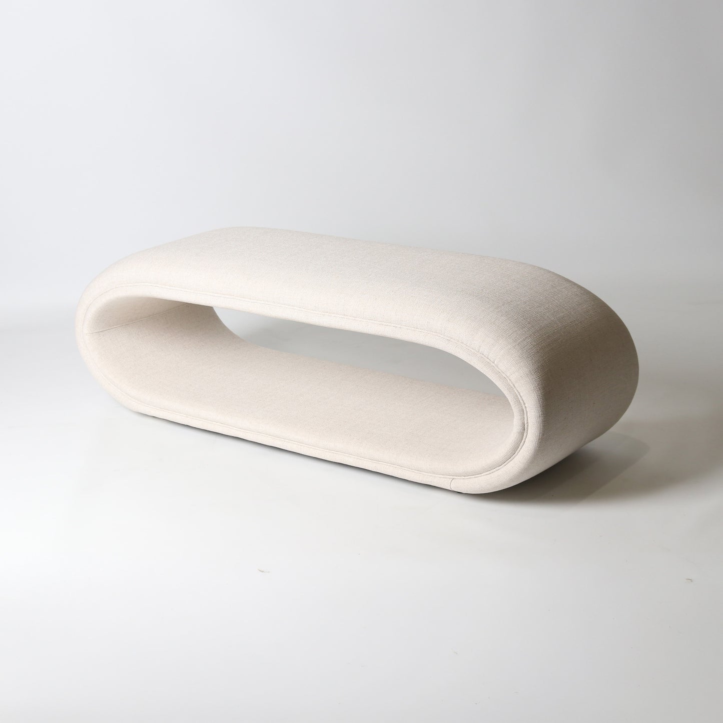 open oval upholstered bench in ivory