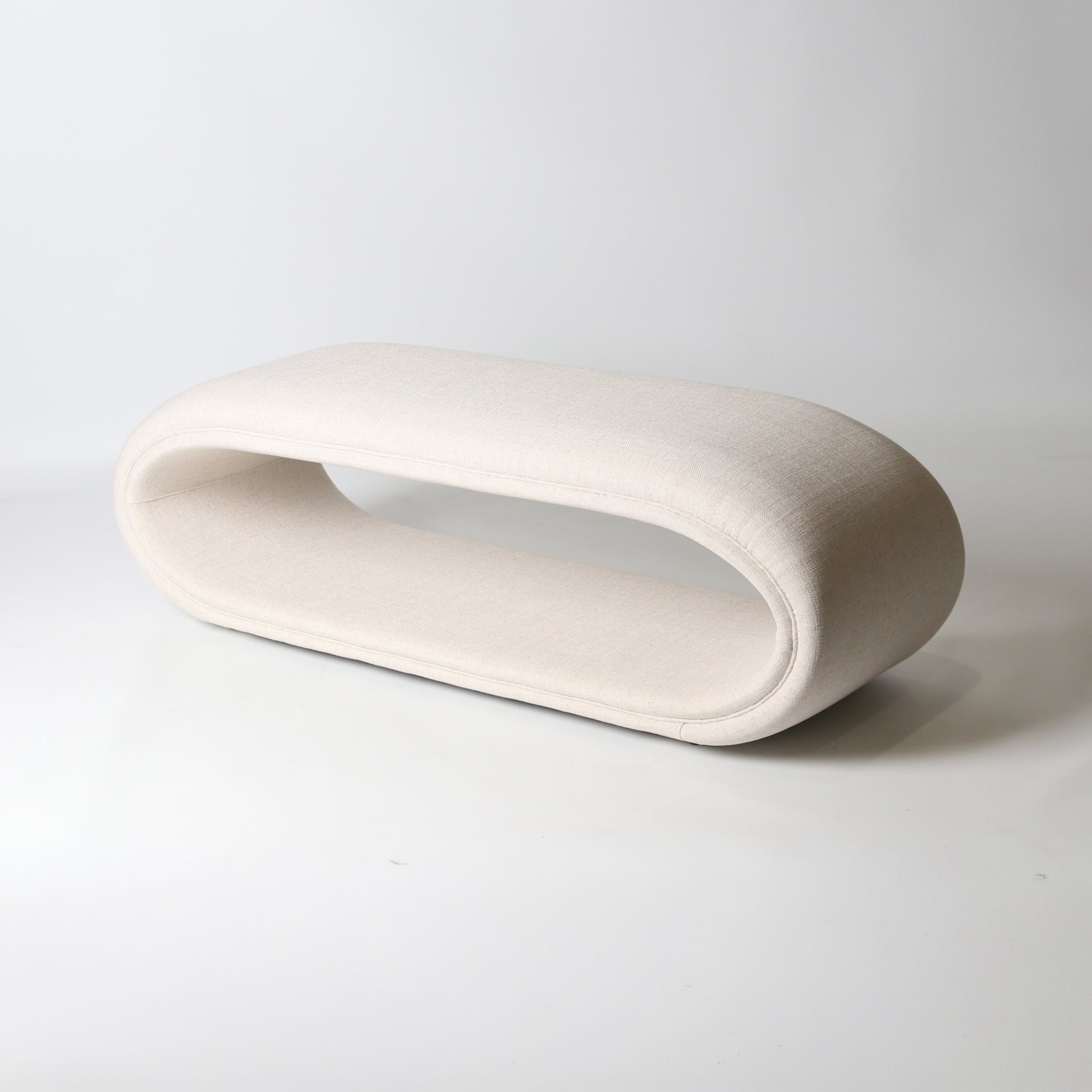 open oval upholstered bench in ivory