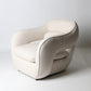 Architectural rounded open sided lounge chair in neutral fabric
