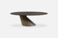 Modern round coffee table with a unique base design on a white background