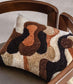 Decorative pillow with abstract pattern on a wooden chair