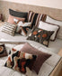 Decorative pillows on a bed with a neutral color scheme