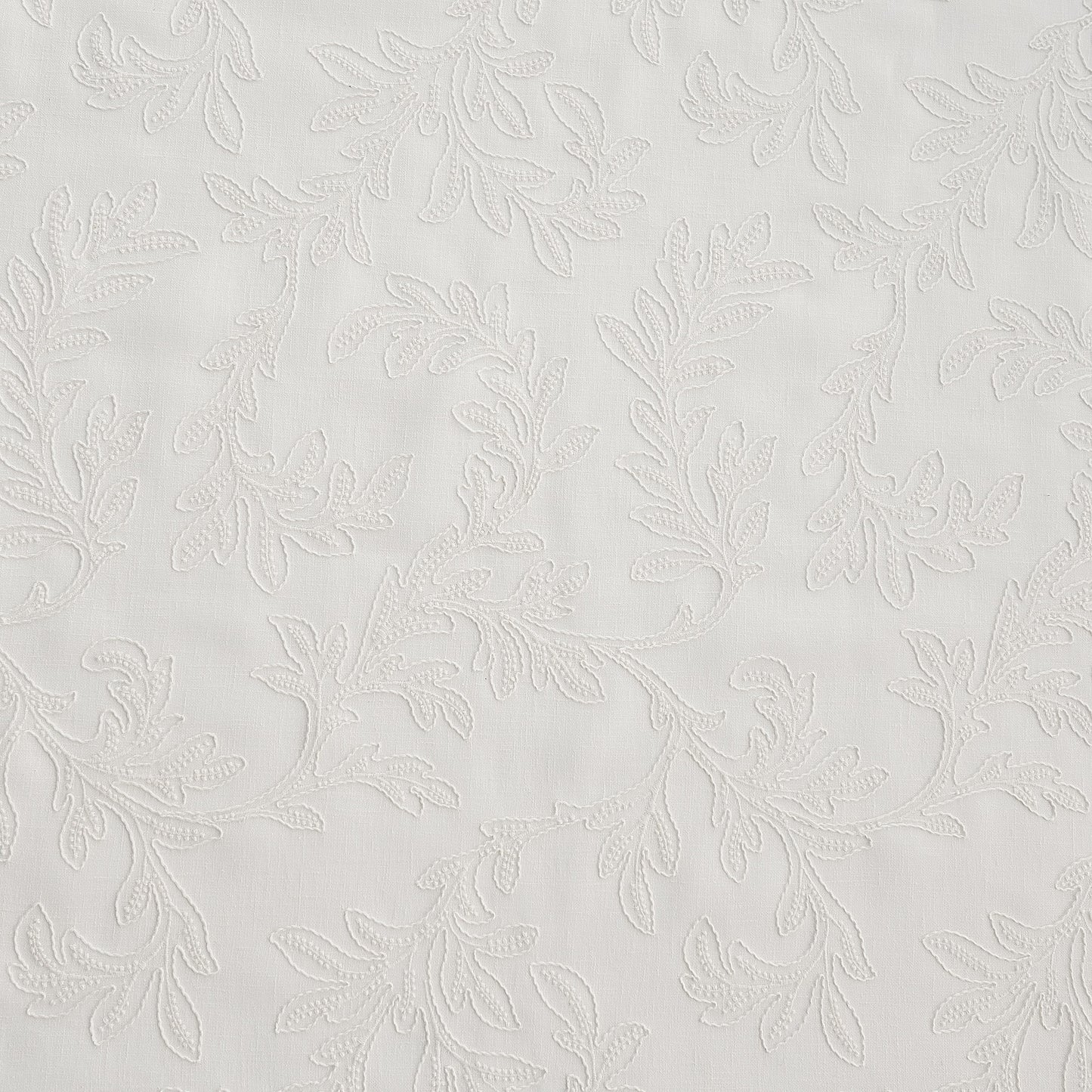 white embroidered drapery fabric wthi leaf pattern