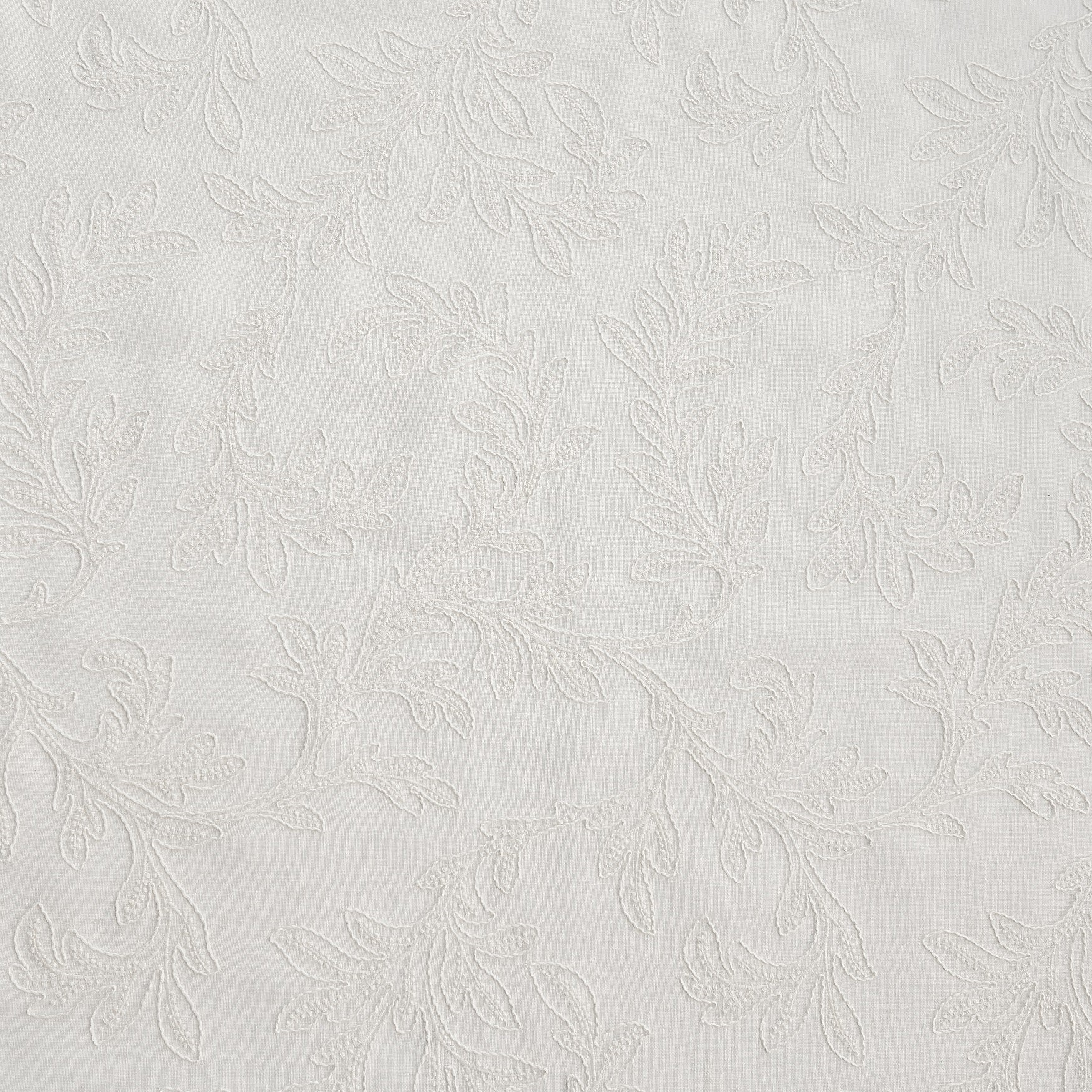 white embroidered drapery fabric wthi leaf pattern