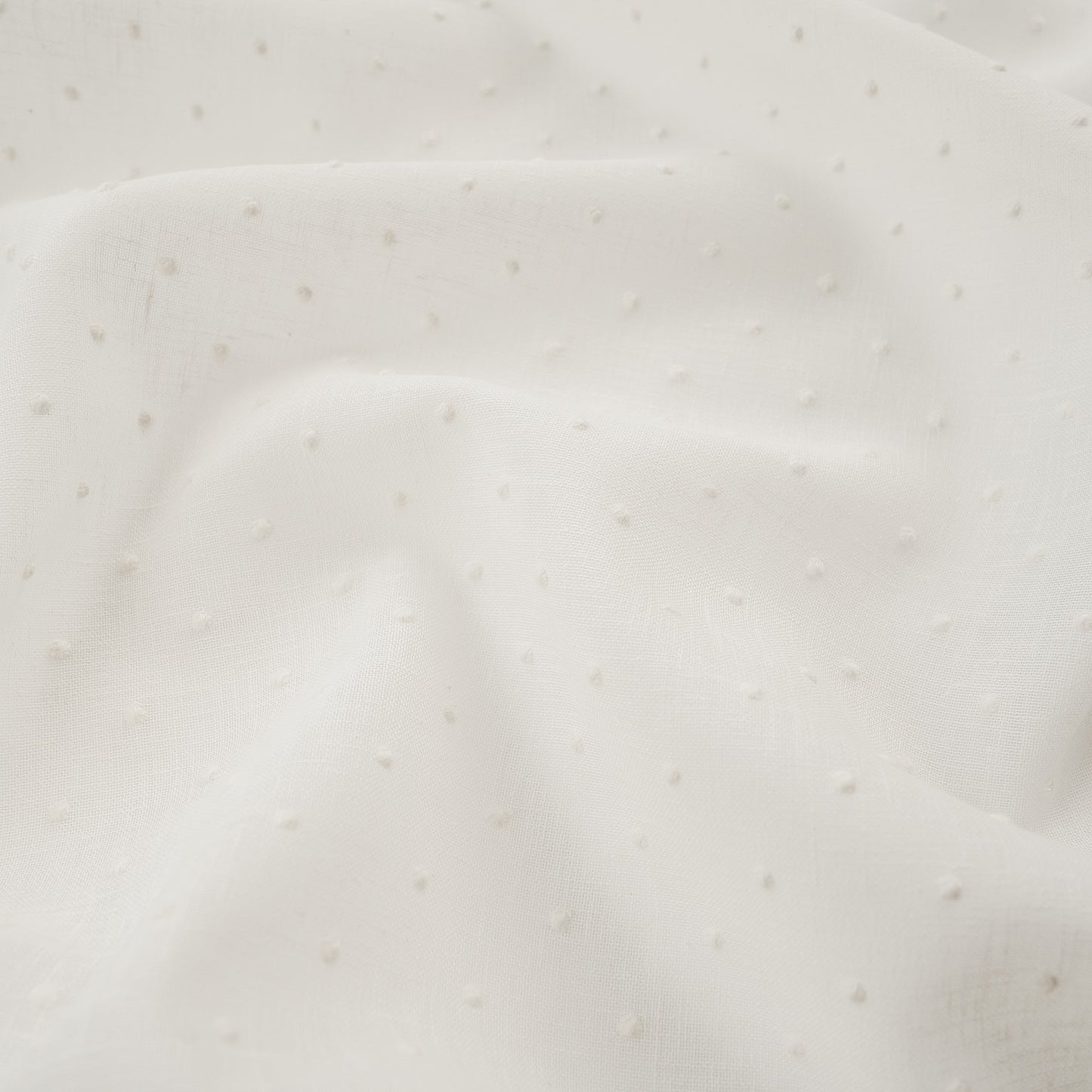 White drapery fabric embroidered with dots