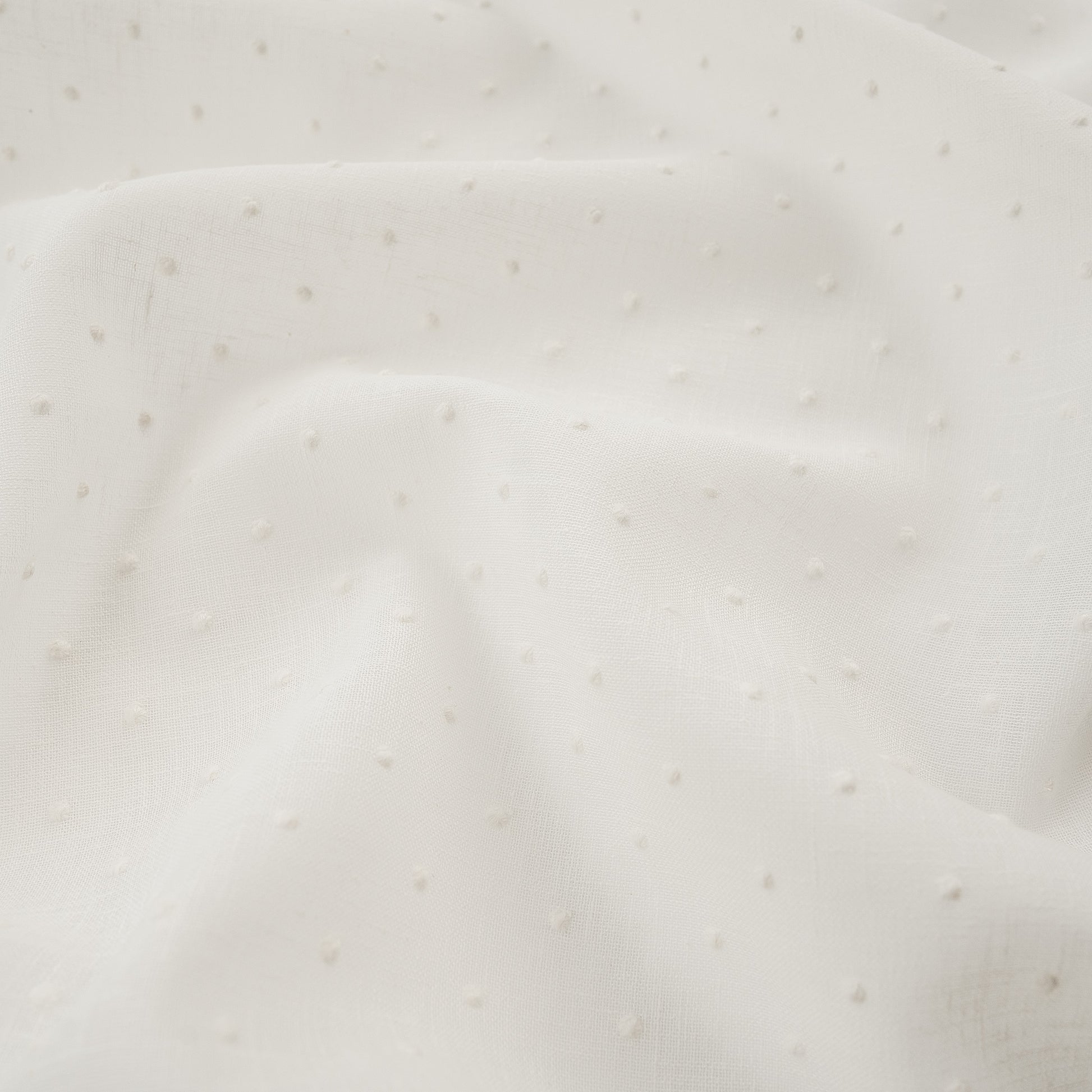 White drapery fabric embroidered with dots
