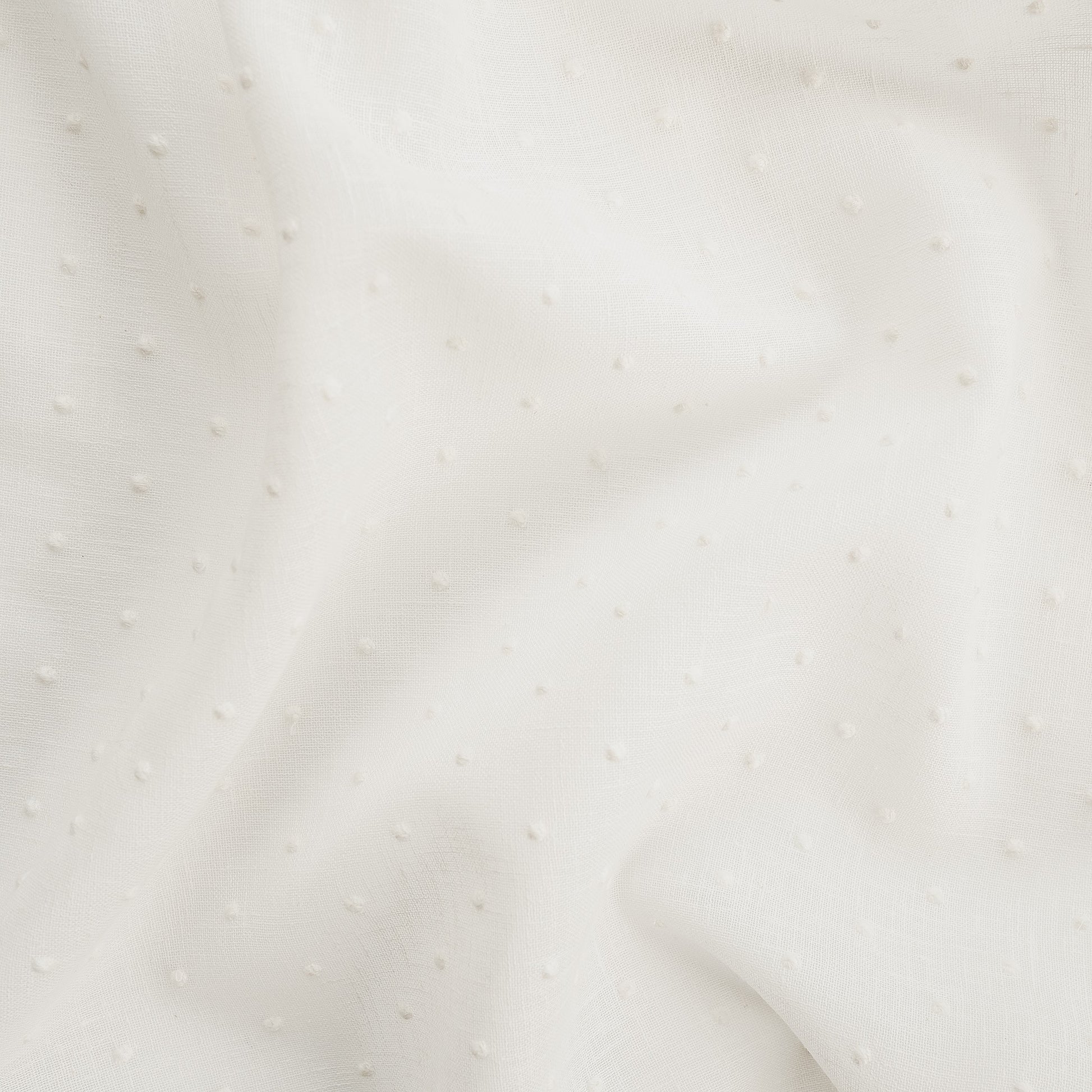 White drapery fabric embroidered with dots