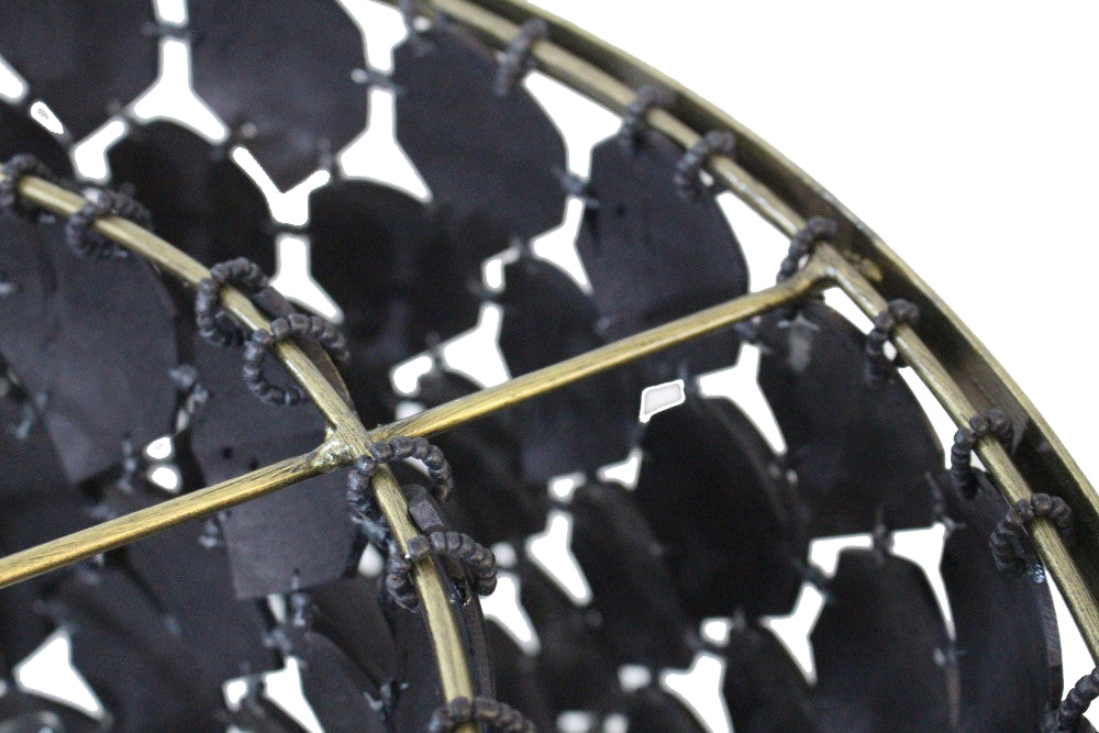 Close-up of a black and gold geometric patterned object
