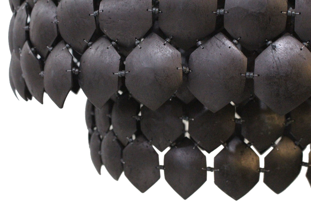 Close-up of a black chainmail armor on a white background