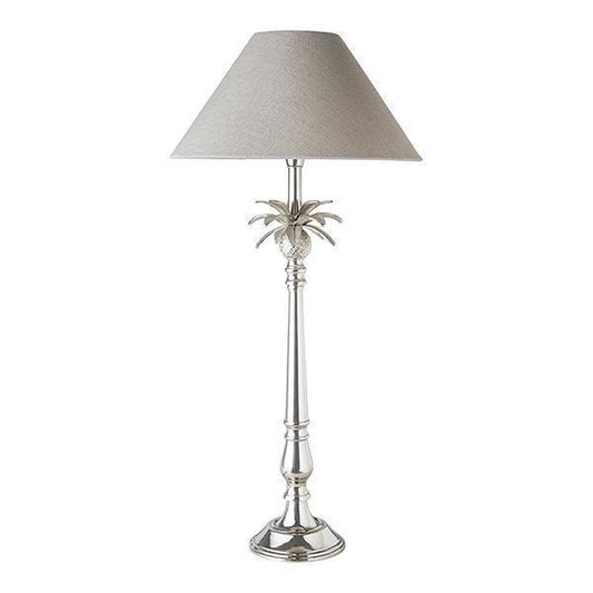 talk nickel lamp with a pineapple and leaves just below the white linen shade