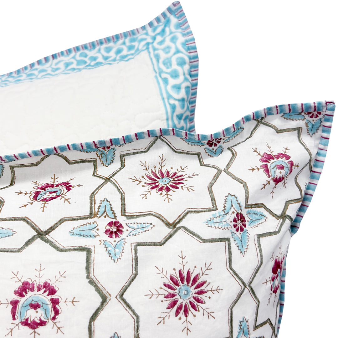 Decorative pillow with floral geometric pattern on a white background