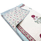 Floral patterned quilt with a folded corner on a white background