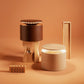 Two cylindrical lamps, one brown and one beige, on an orange background with wooden objects.