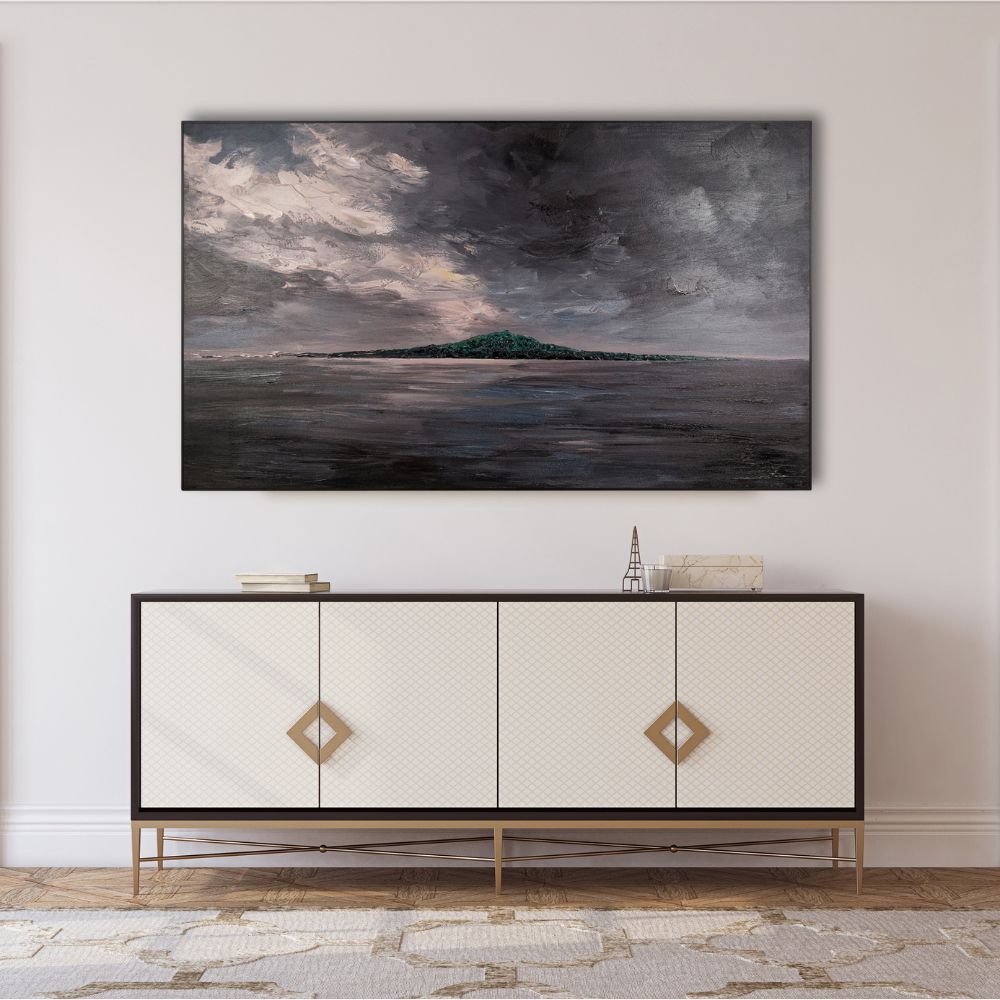 Framed artwork above a decorative cabinet in a room with light-colored walls.