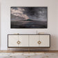 Framed artwork above a decorative cabinet in a room with light-colored walls.