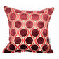 Decorative pillow with red and beige circular pattern on a white background