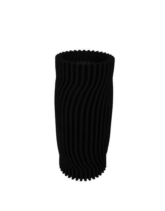 Black ribbed vase on a white background