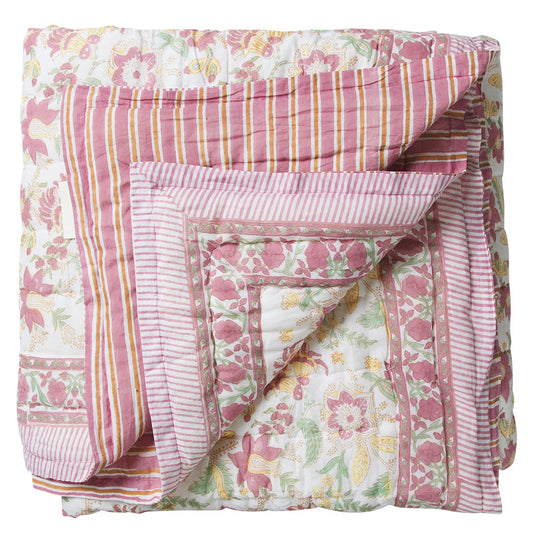 Floral and striped quilt on a white background