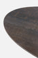Round metal table top with a textured surface on a white background