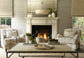 Living room with fireplace, chairs, and a coffee table.