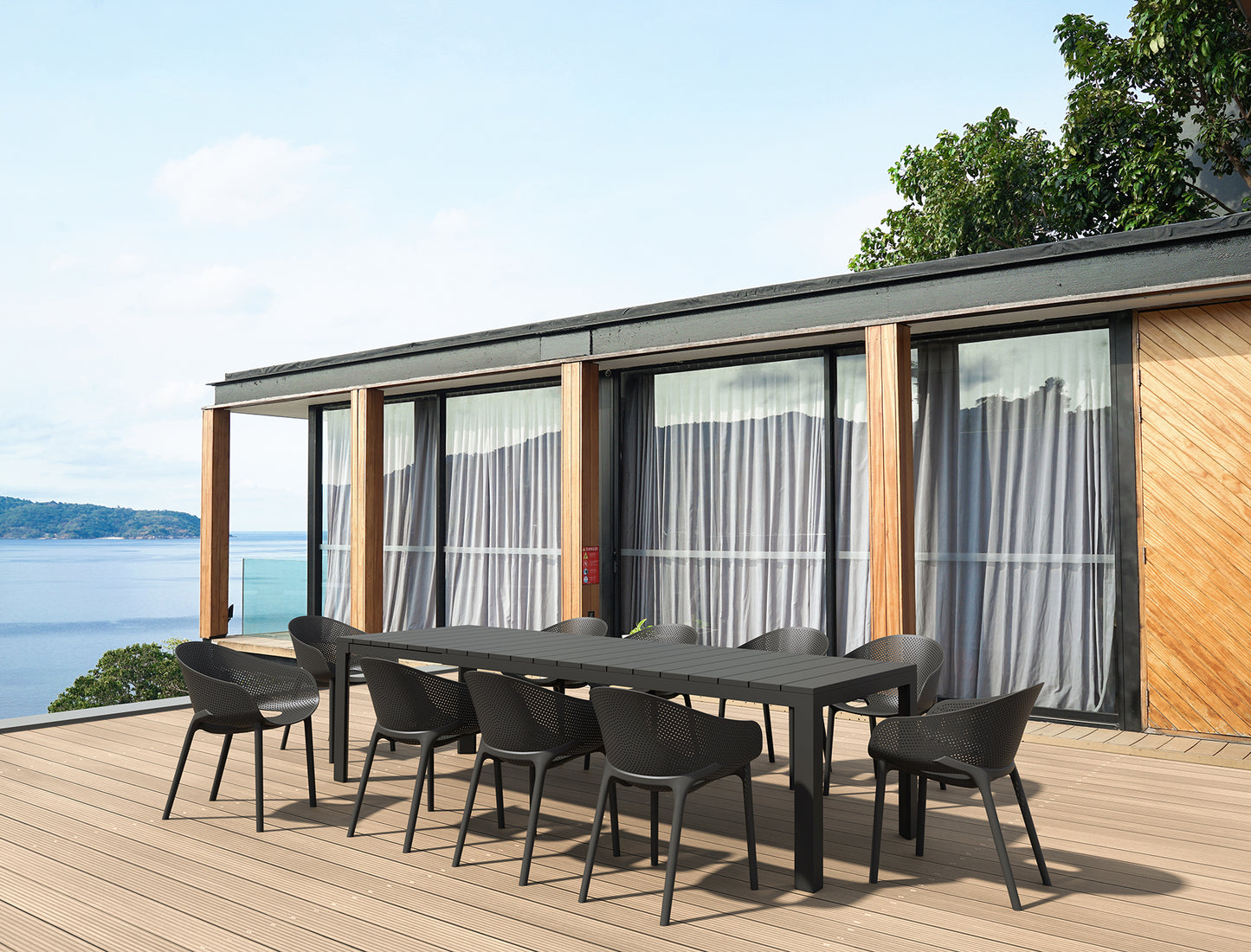 Outdoor dining set on a deck with a scenic view of water and trees.