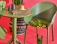 Green chair with a table and decorative items on a red background