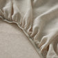 Close-up of Sova linen fitted sheet on a bed