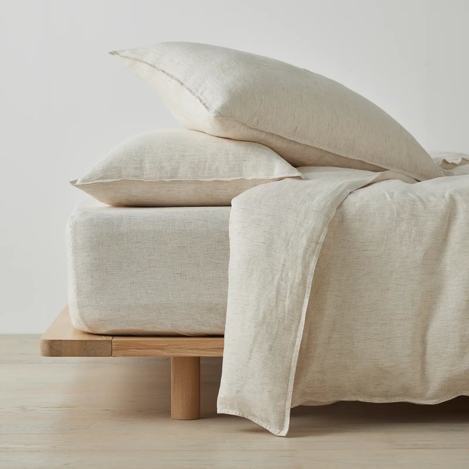 Sova bed linen bedding set on a wooden bed frame against a light background