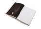 Open book with a dark brown cover and white pages on a white background