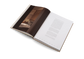 Open book with a wooden texture on one page and text on the other, on a white background