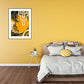 Bedroom with a yellow wall, abstract art, and a bed with striped bedding.
