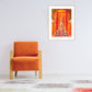 Orange armchair in a room with a colorful abstract painting on the wall.