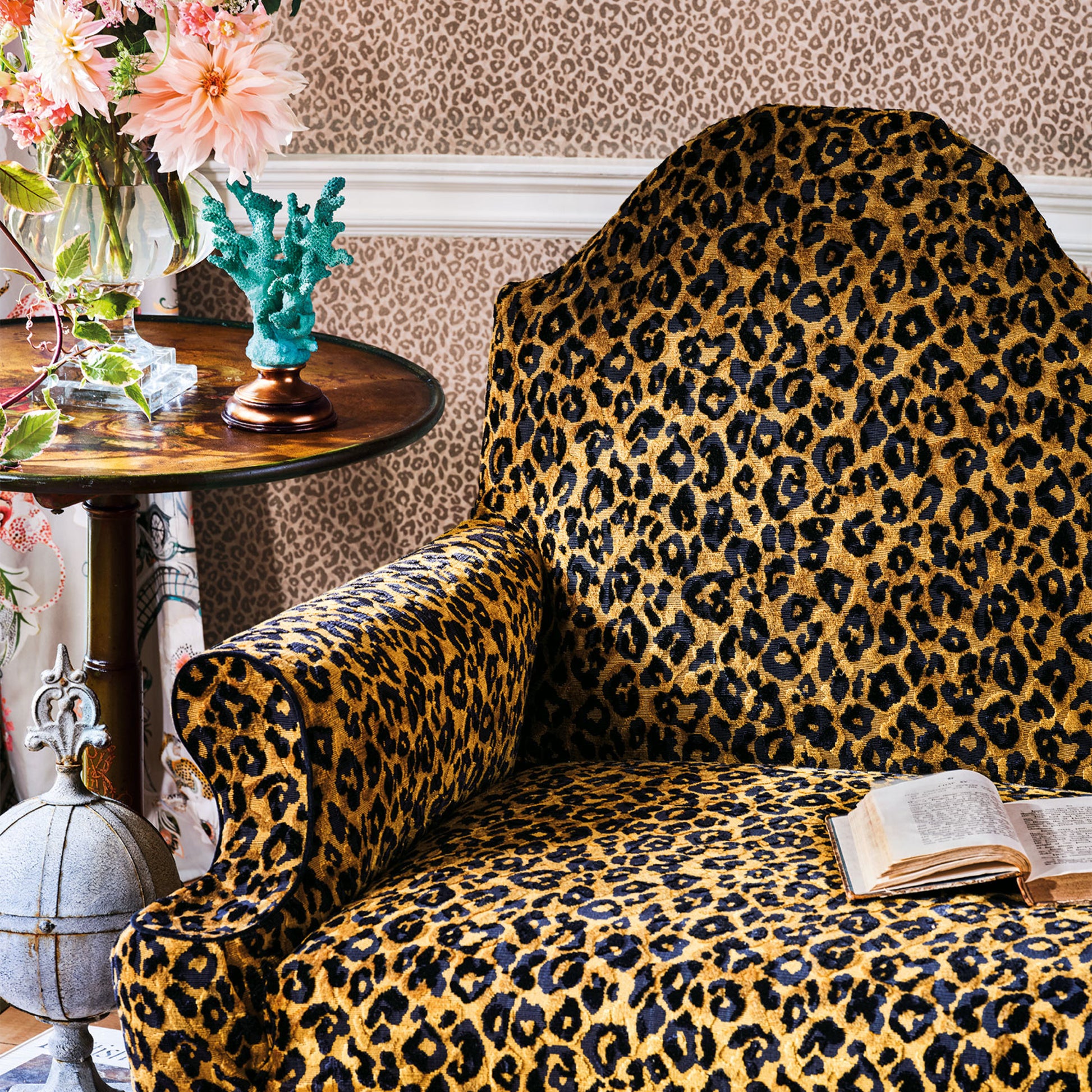 Leopard print armchair in a room with decorative elements.