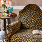 Leopard print armchair in a room with decorative elements.