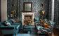 Luxurious living room with patterned wallpaper, teal sofa, and decorative elements.