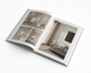 Open book showing interior design images of a bedroom.