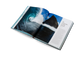 Open book showing a photograph of a wave and text on a white background