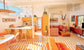 Modern living room with orange furniture and striped floor, mountain view in the background